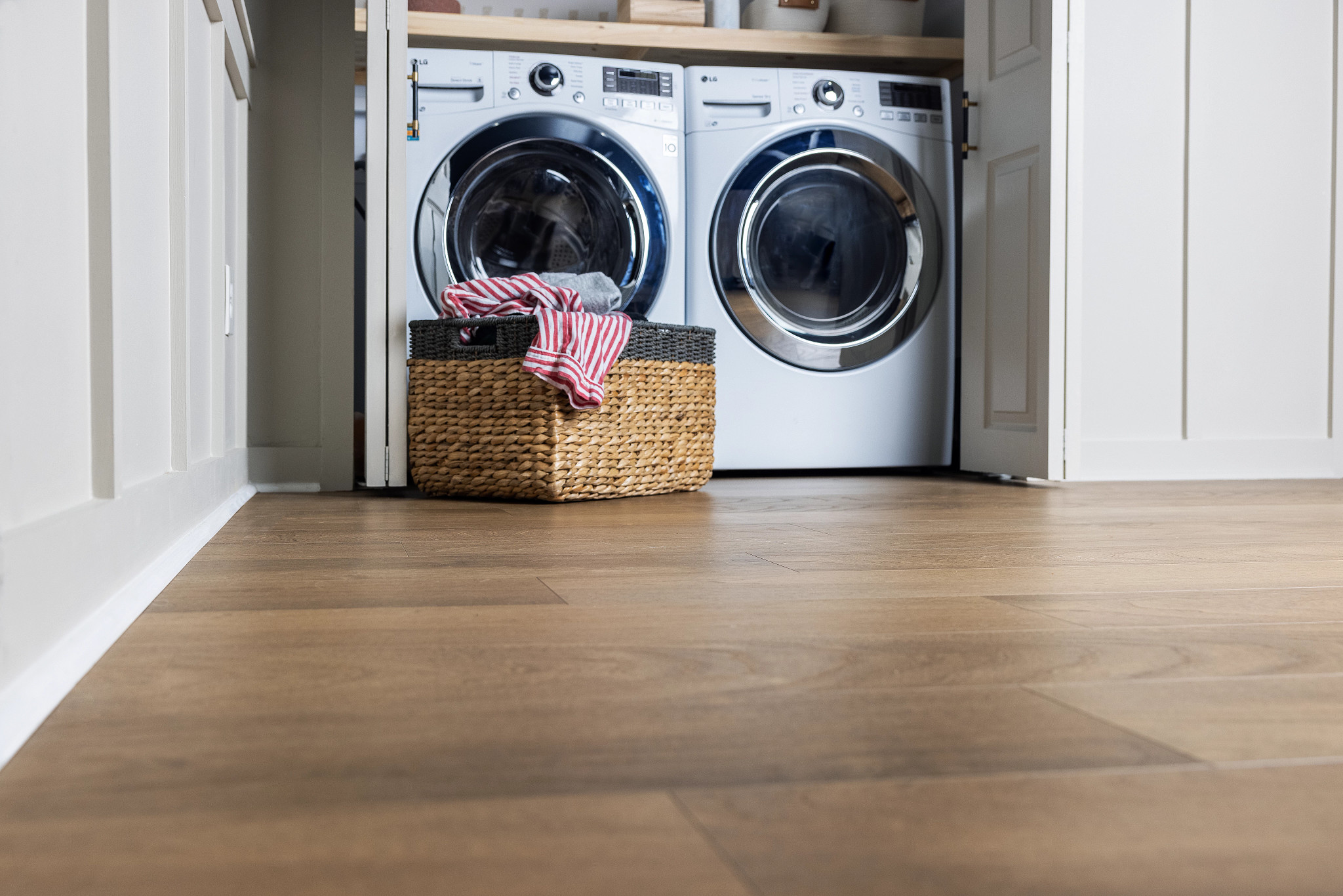 laundry front loading washer and dryer warm brown vinyl floor
